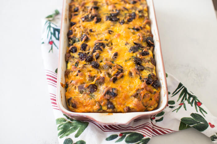 Christmas Breakfast Strata an easy overnight breakfast casserole made with eggs, sourdough bread, chard, mushrooms, and all dat cheese with cherries on top! 