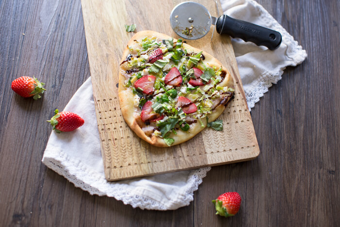 Strawberry Brussels Sprouts Naan Flatbread an easy appetizer or main made that's sweet and savoy. Warm naan bread loaded with shaved Brussels sprouts, strawberry mascarpone, fresh strawberries, and a tangy balsamic drizzle. So good. 