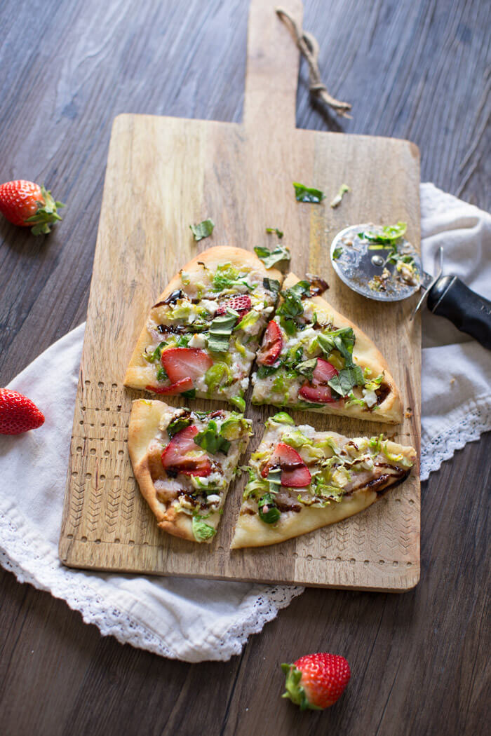 Strawberry Brussels Sprouts Naan Flatbread an easy appetizer or main made that's sweet and savoy. Warm naan bread loaded with shaved Brussels sprouts, strawberry mascarpone, fresh strawberries, and a tangy balsamic drizzle. So good. 