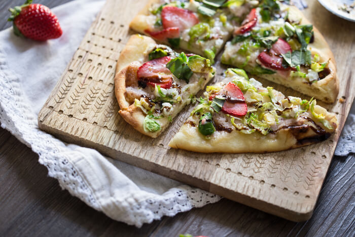 Strawberry Brussels Sprouts Naan Flatbread an easy appetizer or main made that's sweet and savoy. Warm naan bread loaded with shaved Brussels sprouts, strawberry mascarpone, fresh strawberries, and a tangy balsamic drizzle. So good. 