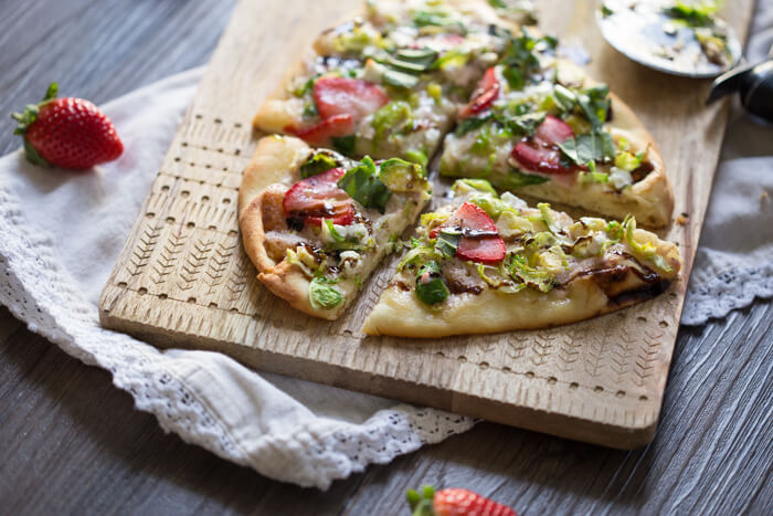 Strawberry Brussels Sprouts Naan Flatbread an easy appetizer or main made that's sweet and savoy. Warm naan bread loaded with shaved Brussels sprouts, strawberry mascarpone, fresh strawberries, and a tangy balsamic drizzle. So good. 