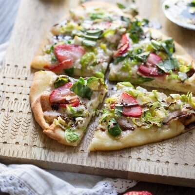 Strawberry Brussels Sprouts Naan Flatbread an easy appetizer or main made that's sweet and savoy. Warm naan bread loaded with shaved Brussels sprouts, strawberry mascarpone, fresh strawberries, and a tangy balsamic drizzle. So good. 