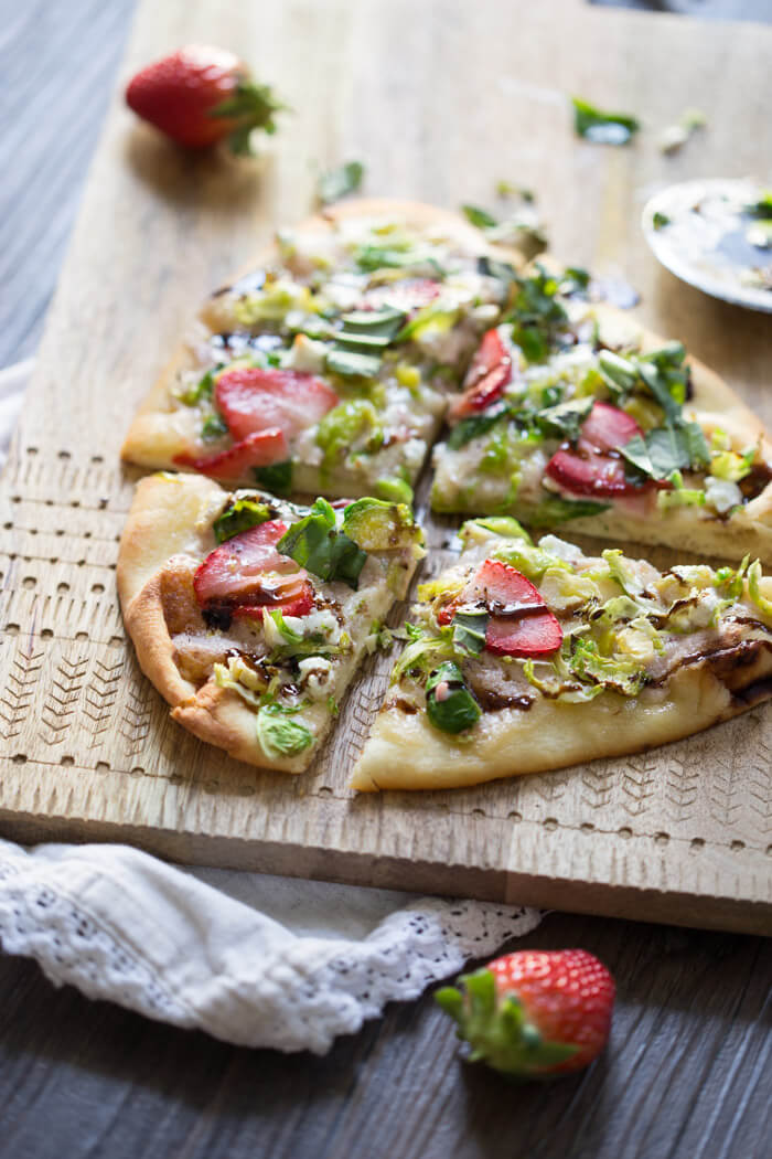 Strawberry Brussels Sprouts Naan Flatbread an easy appetizer or main made that's sweet and savoy. Warm naan bread loaded with shaved Brussels sprouts, strawberry mascarpone, fresh strawberries, and a tangy balsamic drizzle. So good. 