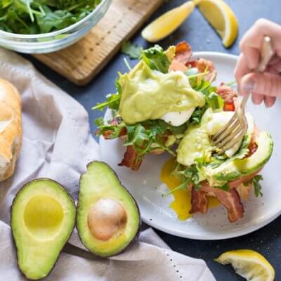 Eggs Benedict BLT with Avocado Hollandaise, a hearty comforting breakfast recipe that's packed with nutrition thanks to avocados.