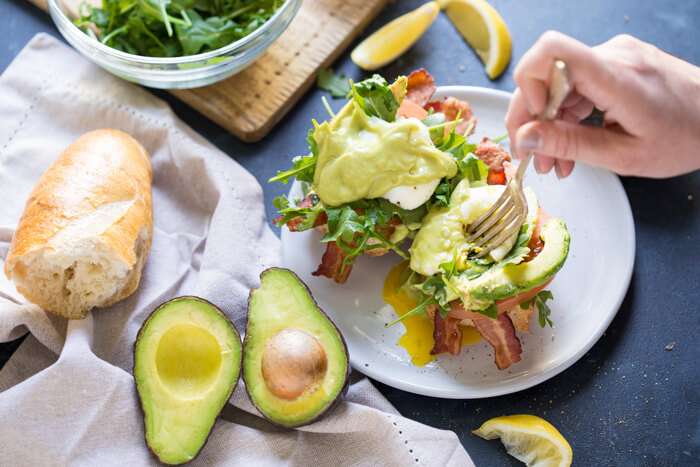 Eggs Benedict BLT with Avocado Hollandaise, a hearty comforting breakfast recipe that's packed with nutrition thanks to avocados.