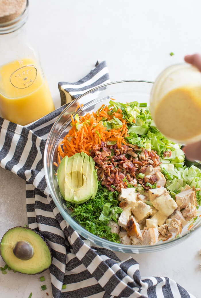 OH ME OH MY! This Farmhouse Chicken Chopped Salad with romaine, cabbage, kale, carrots, grilled chicken breast, bacon, sunflower seeds and avocado tossed in a tangy orange honey mustard dressing is my jam.