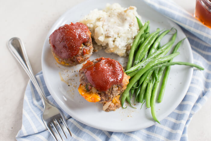 Cheesy Meatloaf Minis made in the muffin tin and full of hidden veggies. Freezer friendly, family friendly weeknight meal that's gluten free.