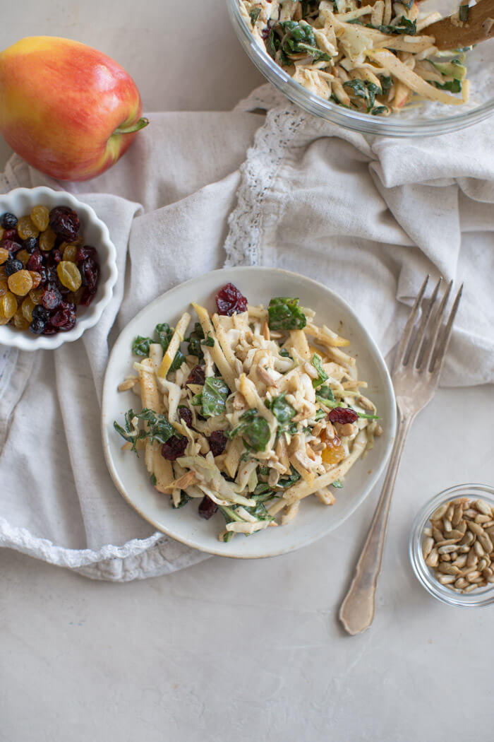 Apple Crunch Slaw with Almond Butter Dressing... yep, let's talk legit fall food over here. We love the crunch in this plant-based salad from all the shredded veggies, apples, and sunflower seeds.