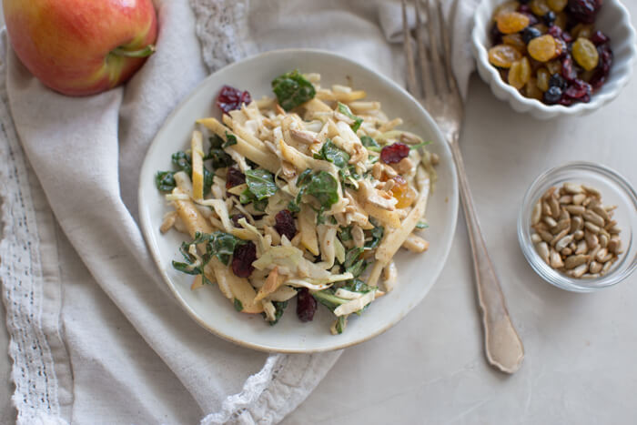 Apple Crunch Slaw with Almond Butter Dressing... yep, let's talk legit fall food over here. We love the crunch in this plant-based salad from all the shredded veggies, apples, and sunflower seeds.