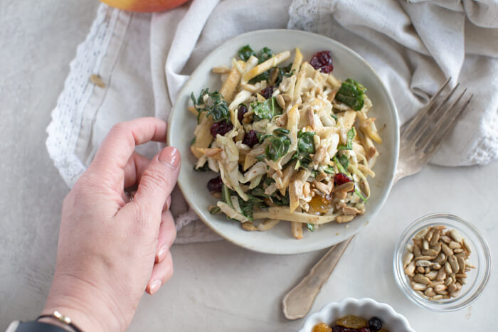 Apple Crunch Slaw with Almond Butter Dressing... yep, let's talk legit fall food over here. We love the crunch in this plant-based salad from all the shredded veggies, apples, and sunflower seeds.