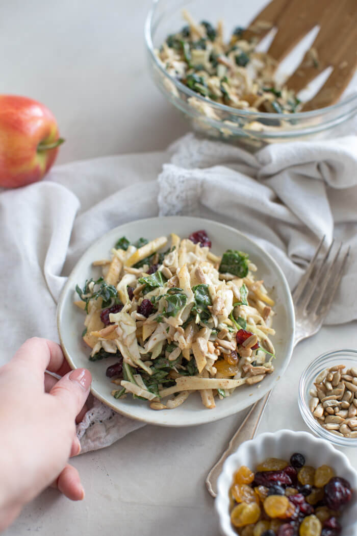 Apple Crunch Slaw with Almond Butter Dressing... yep, let's talk legit fall food over here. We love the crunch in this plant-based salad from all the shredded veggies, apples, and sunflower seeds.