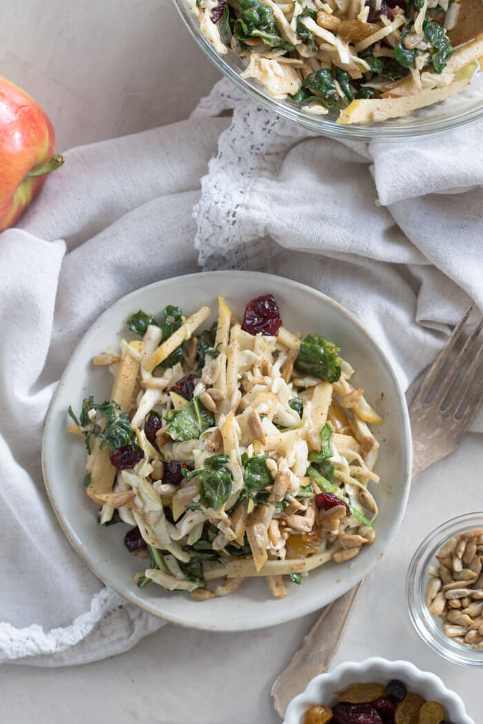 Apple Crunch Slaw with Almond Butter Dressing... yep, let's talk legit fall food over here. We love the crunch in this plant-based salad from all the shredded veggies, apples, and sunflower seeds.