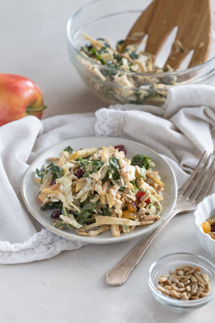 Apple Crunch Slaw with Almond Butter Dressing... yep, let's talk legit fall food over here. We love the crunch in this plant-based salad from all the shredded veggies, apples, and sunflower seeds.