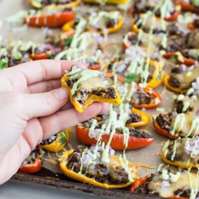 Mini Bell Pepper Nachos with Avocado Cream made on a sheet pan. These plant based mushroom loaded nachos with cool avocado cream are a veggie lovers dream.