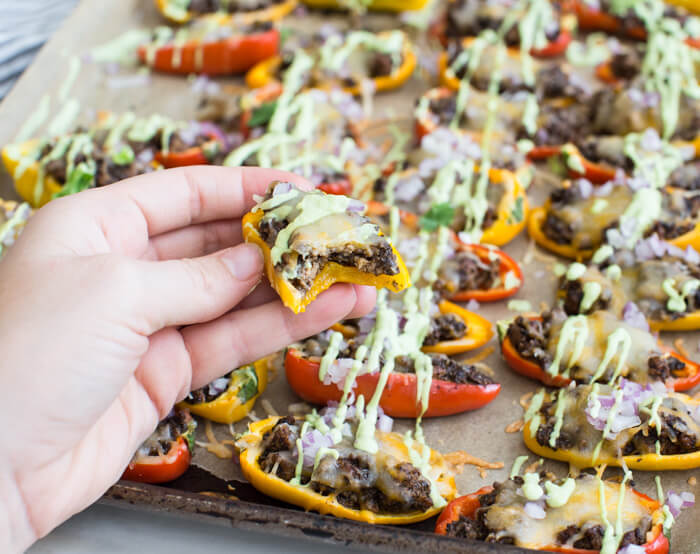 Mini Bell Pepper Nachos with Avocado Cream made on a sheet pan. These plant based mushroom loaded nachos with cool avocado cream are a veggie lovers dream. 