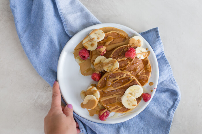 These fluffy peanut butter protein pancakes are protein packed with cottage cheese and peanut powder and made straight in the blender for easy mixing. Meal prep these peanut butter protein pancakes to freeze and reheat for quick breakfast, brinner, or pre/post workout fuel. 