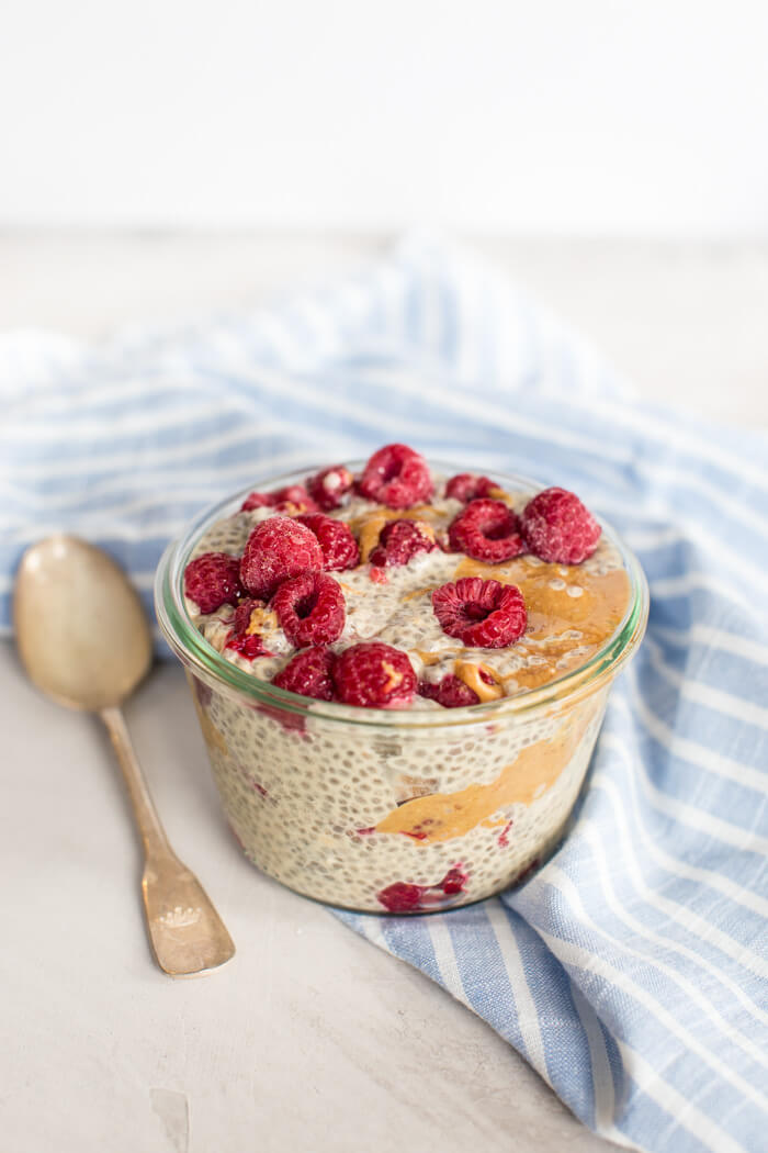 close up of chia seed pudding with raspberries and peanut butter