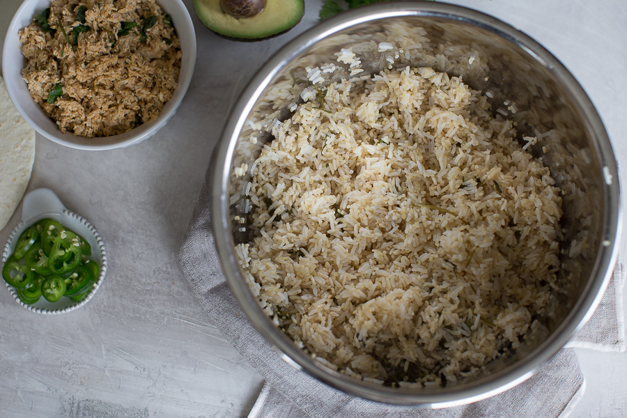 overhead shot of cilantro lime rice in the Instant Pot with side of jalapeños and shredded chicken