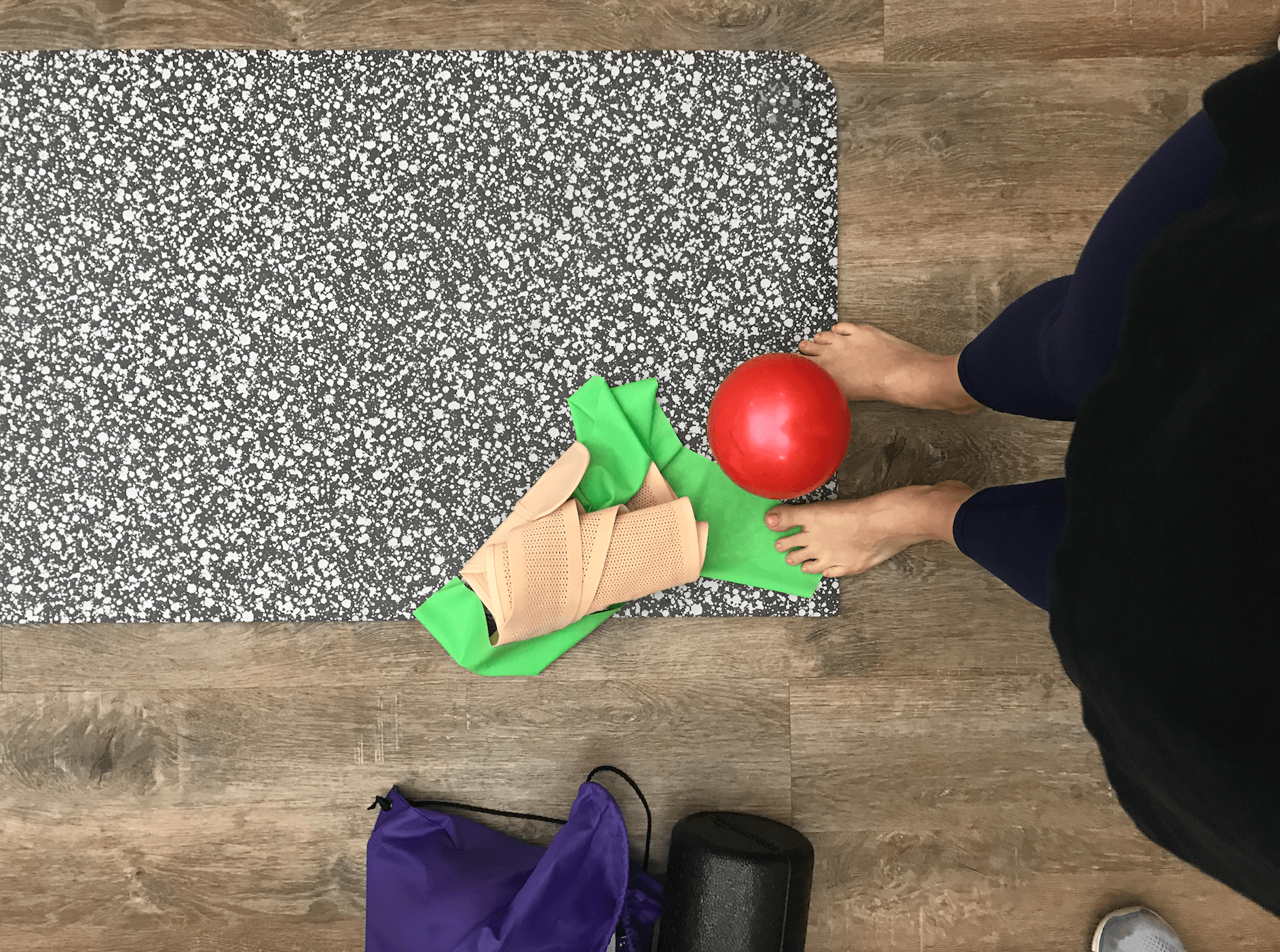 postpartum girdle and exercise ball on yoga mat