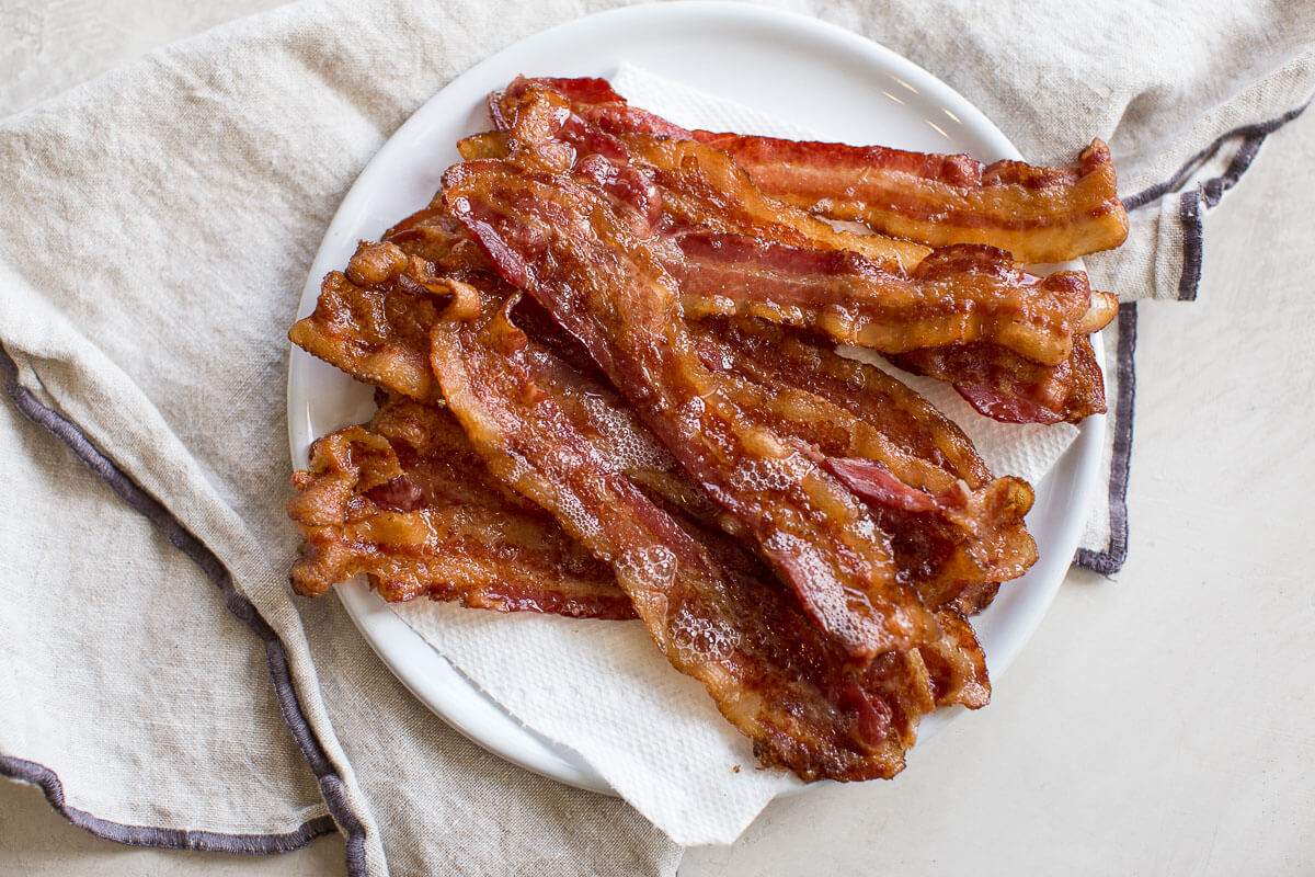 overhead shot of plate of bacon after baking in the oven