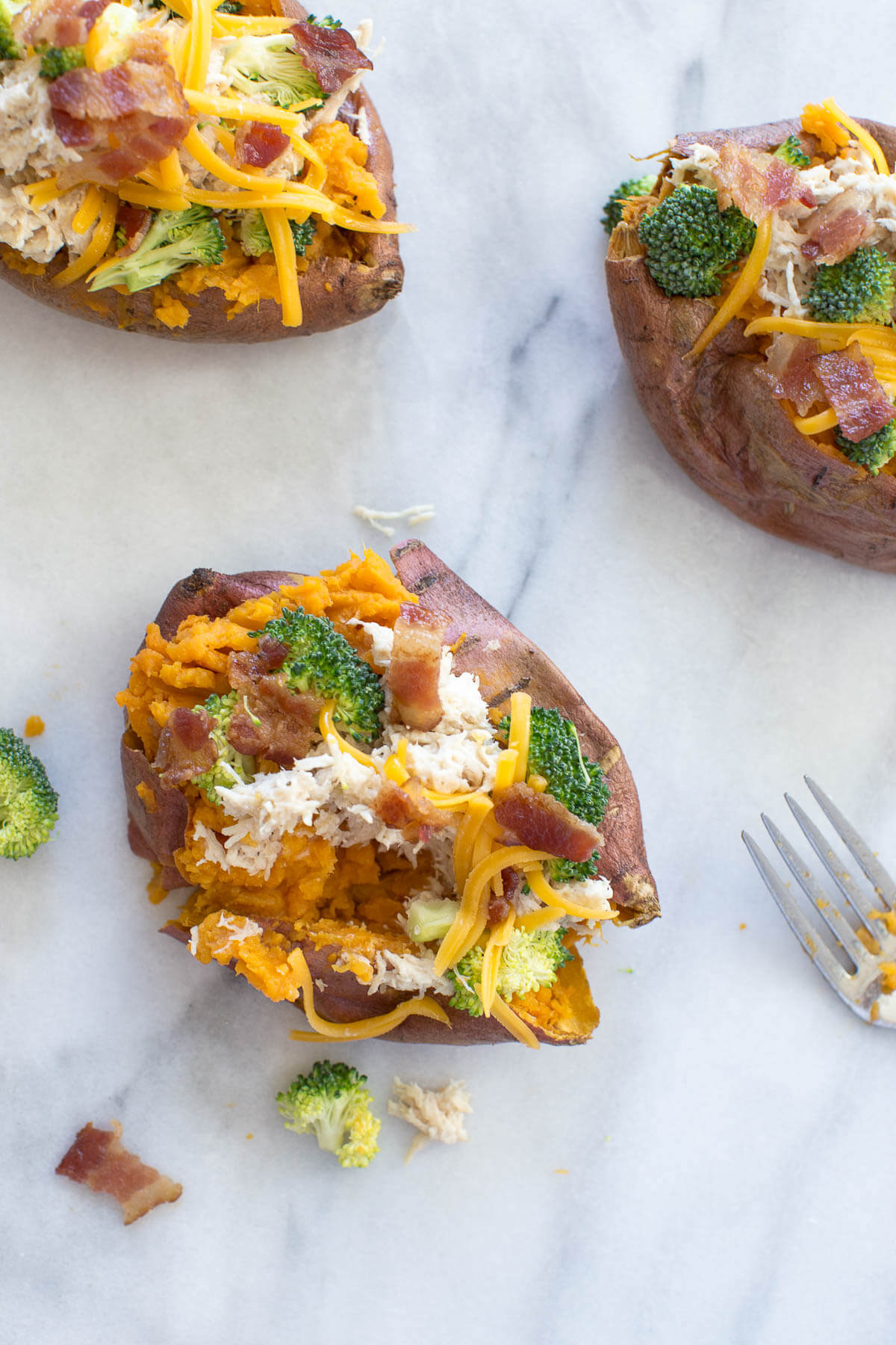 close up shot of crack chicken and broccoli stuffed into sweet potato 