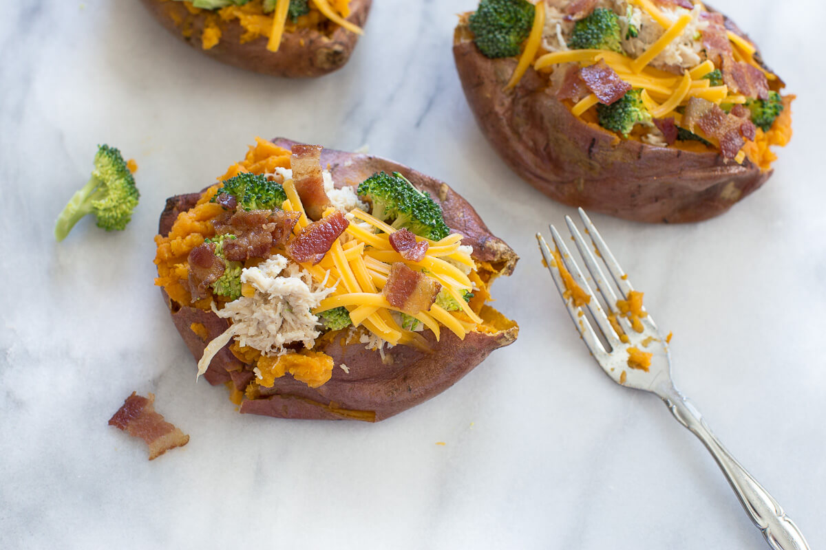 overhead shot of fork and sweet potato stuffed with crack chicken, broccoli and shredded cheese 