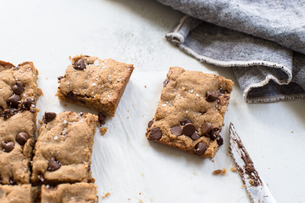 Overhead shot of almond butter blondie with chocolate chips and sprinkled with sea salt 