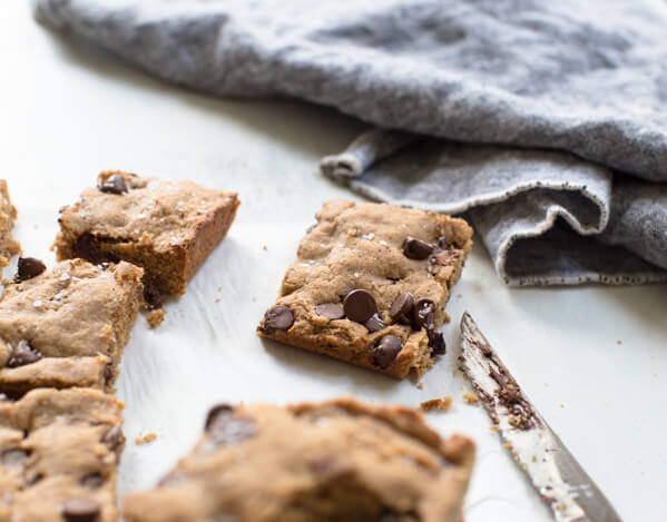 Side shot of almond butter blondie bar with chocolate ships and sea salt 