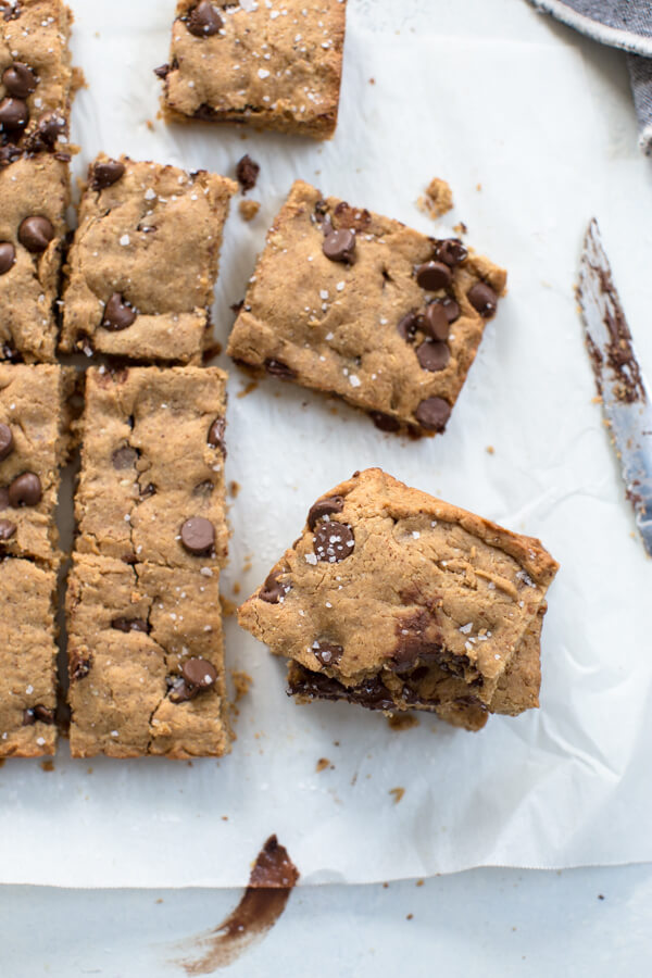 Overhead shot of stacked almond butter blondies with chocolate chips and sprinkled with sea salt