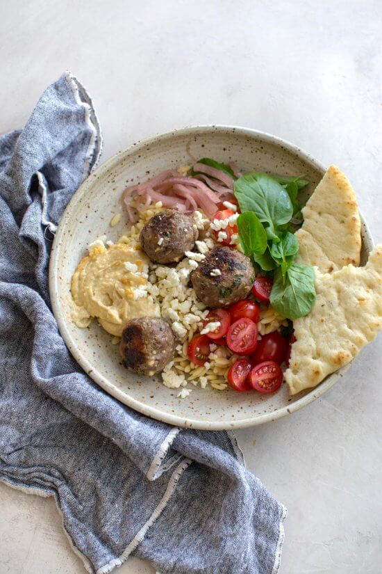 how to cook meatballs in the oven with ground lamb, feta cheese, red onion, and greek spices