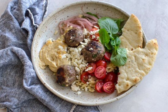 easy meatballs baked in the oven with feta cheese, red onion, and greek spices