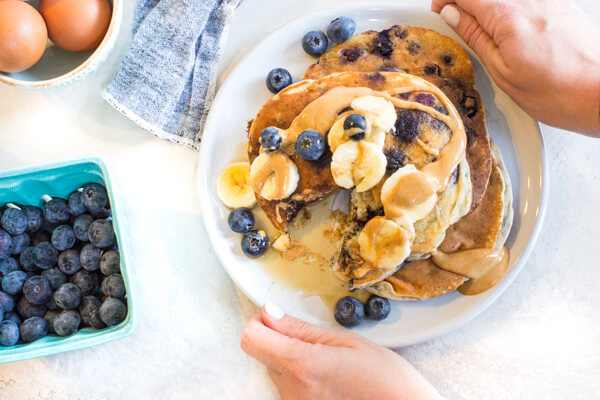 protein pancakes with almond flour, blueberries, bananas and maple syrup