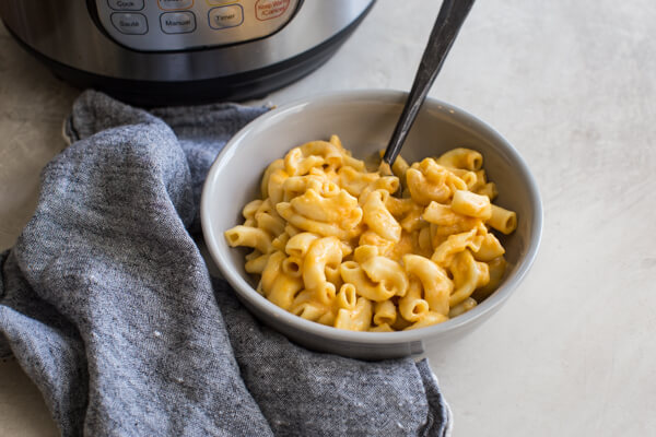 This is the best Instant Pot Mac and Cheese recipe with hidden veggies-- it's a fan favorite kid friendly meal around here. Easy homemade mac n cheese recipe ready in 5 minutes! Woot woot!