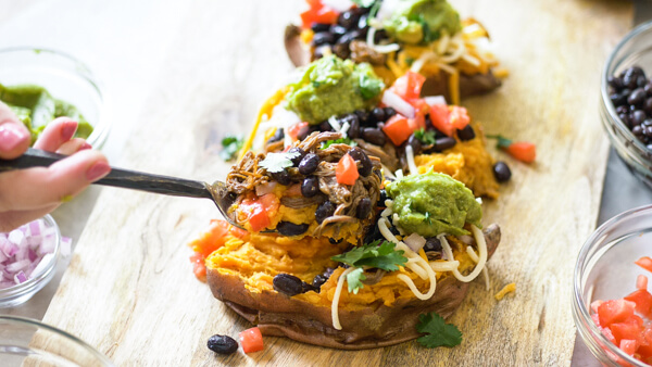 This Slow Cooker Carne Asada recipe is so easy to make with an authentic carne aside marinade stuffed into a microwaved sweet potato. Genius! 