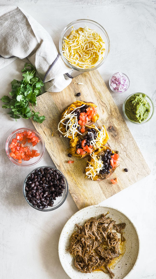 This Slow Cooker Carne Asada recipe is so easy to make with an authentic carne aside marinade stuffed into a microwaved sweet potato. Genius! 