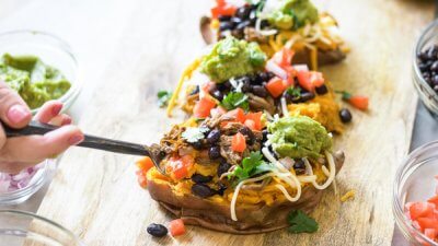 This Slow Cooker Carne Asada recipe is so easy to make with an authentic carne aside marinade stuffed into a microwaved sweet potato. Genius! 