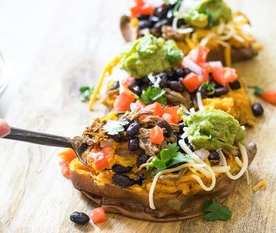 This Slow Cooker Carne Asada recipe is so easy to make with an authentic carne aside marinade stuffed into a microwaved sweet potato. Genius! 