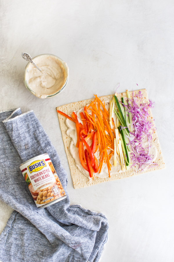 Easy pinwheel recipe for kids = Rainbow Veggie Pinwheels. A veggie loaded kid friendly lunch box recipe made with white bean hummus that encourages them to eat the rainbow. #pinwheels #veggie #rainbow #kidfriendly #lunchboxideas #healthykidrecipes