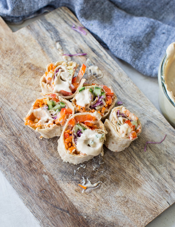 Easy pinwheel recipe for kids = Rainbow Veggie Pinwheels. A veggie loaded kid friendly lunch box recipe made with white bean hummus that encourages them to eat the rainbow. #pinwheels #veggie #rainbow #kidfriendly #lunchboxideas #healthykidrecipes