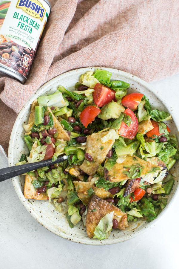 How to make Fiesta Fattoush Salad with fried flour tortillas, black beans, and homemade cilantro lime dressing. Easy weeknight dinner packed with veggies.