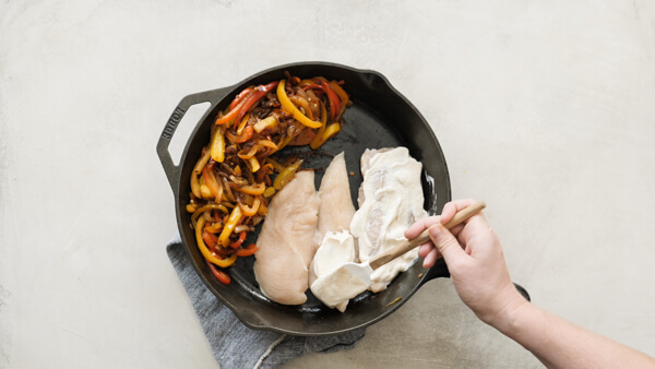 Chicken Fajita Casserole -- easy weeknight recipe with fajita veggies, black beans, sour cream and cheese on chicken breasts & baked in a cast iron skillet.