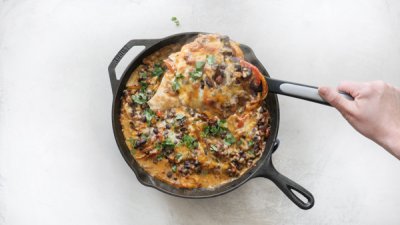 Chicken Fajita Casserole -- easy weeknight recipe with fajita veggies, black beans, sour cream and cheese on chicken breasts & baked in a cast iron skillet.