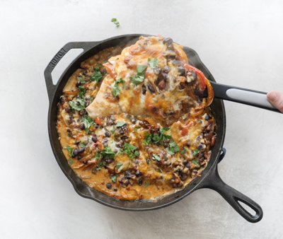 Chicken Fajita Casserole -- easy weeknight recipe with fajita veggies, black beans, sour cream and cheese on chicken breasts & baked in a cast iron skillet.